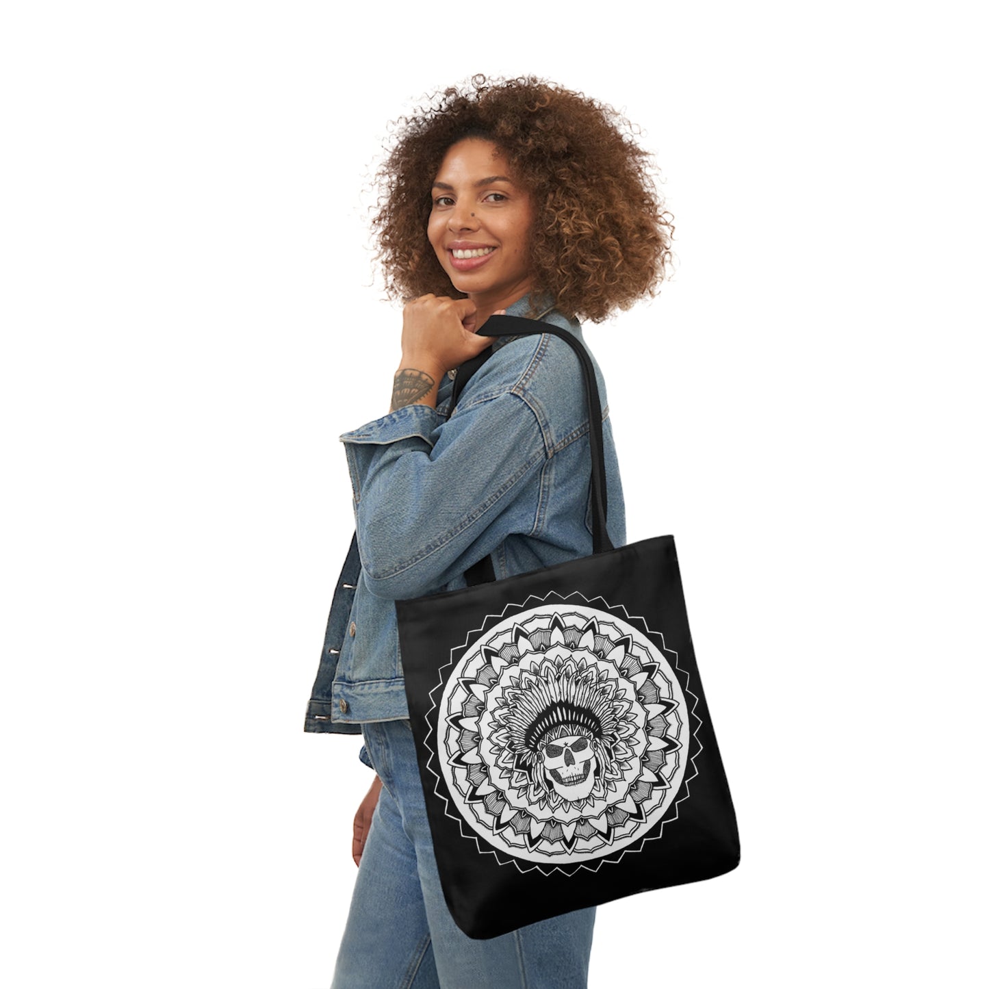 smiling woman holding black mandalarian brand tote bag with black handle and chieftain skull tattoo design print on both sides