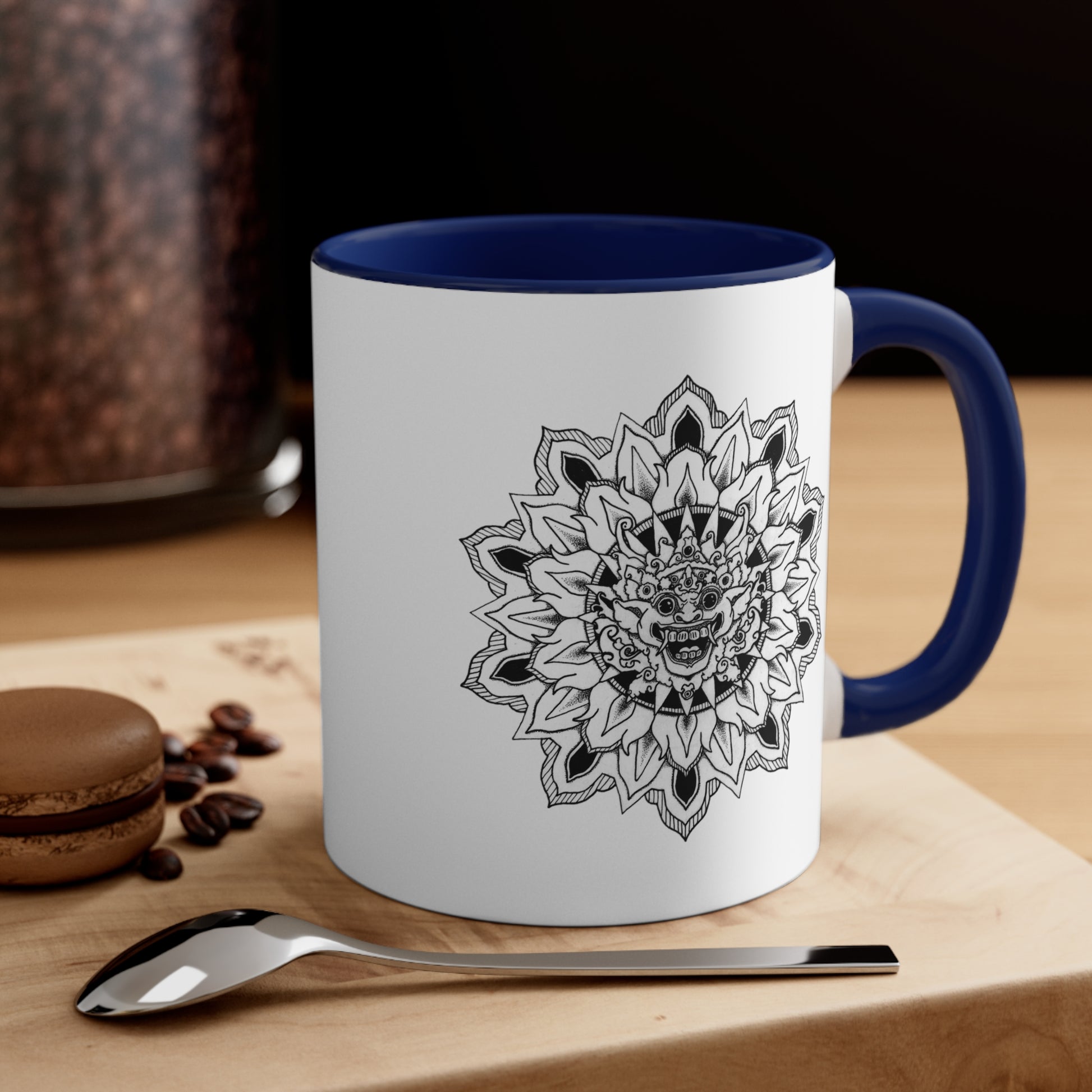 a two-toned white and navy blue 11oz coffee mug with bhoma bali god mandala design on both sides