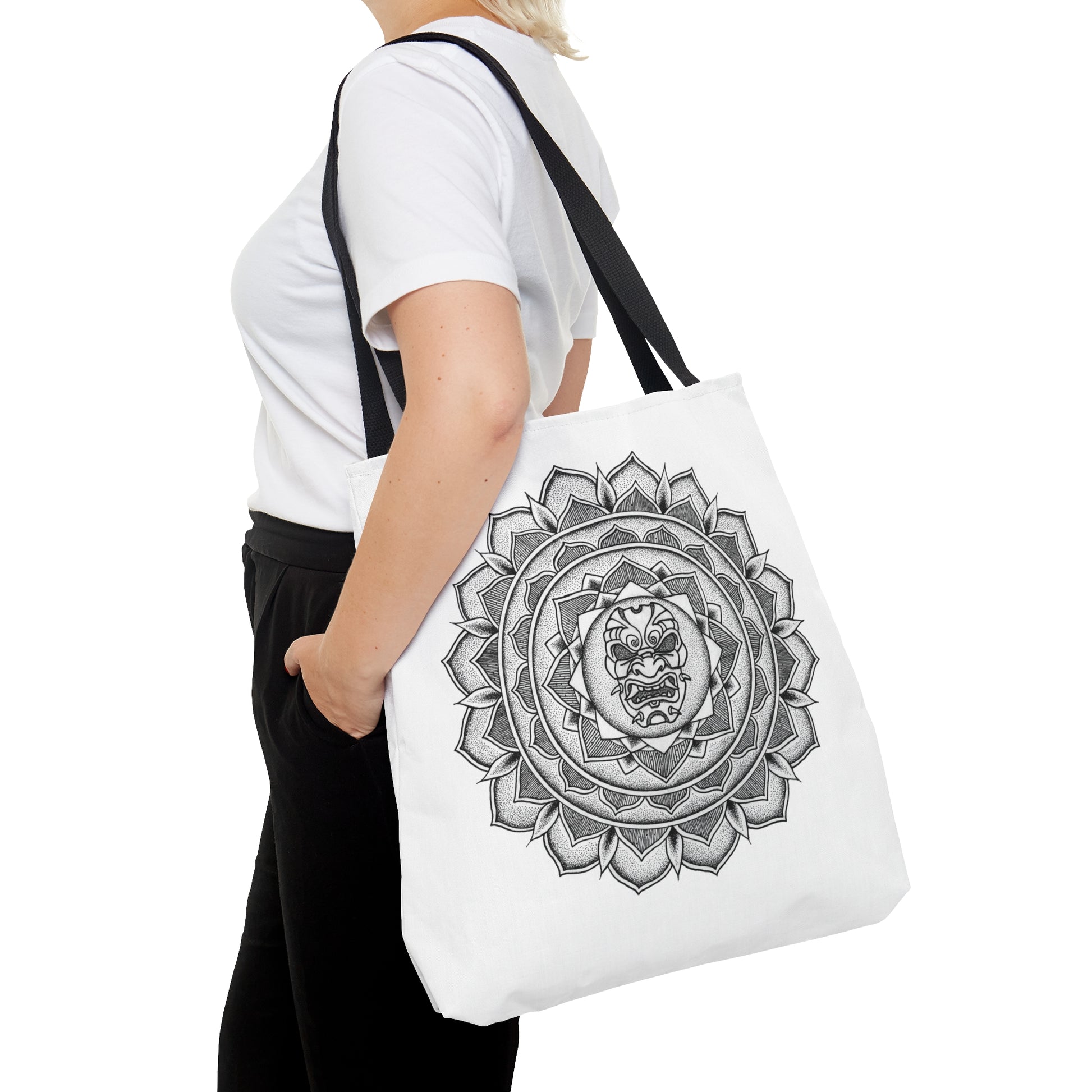 woman holding white mandalarian brand tote bag with black handle and samurai mask design print on both sides