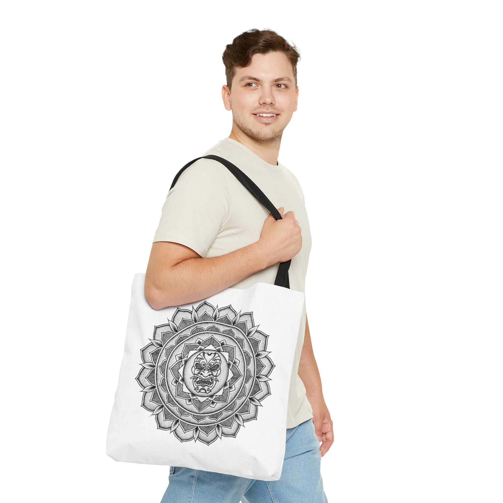 man smiling holding white mandalarian brand tote bag with black handle and samurai mask design print on both sides