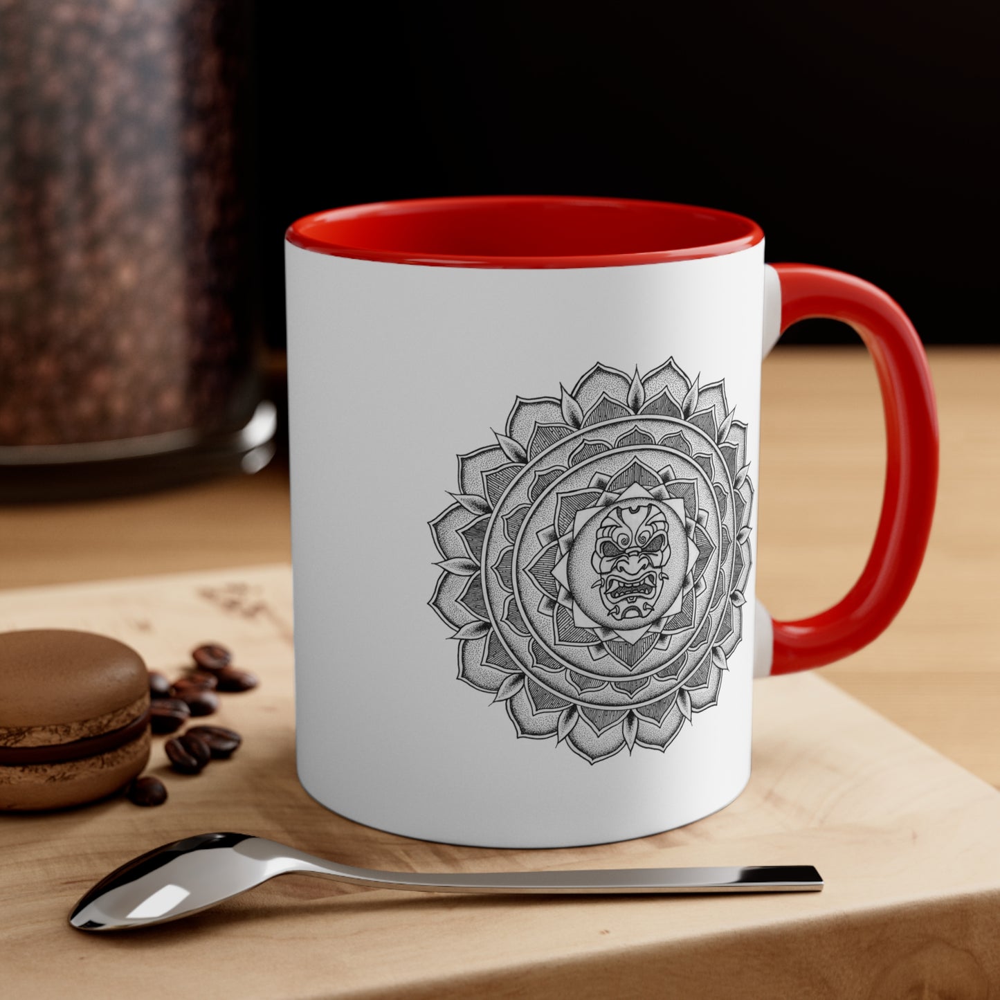 a two toned white and red 11oz coffee mug on a table with a samurai mask mandala design