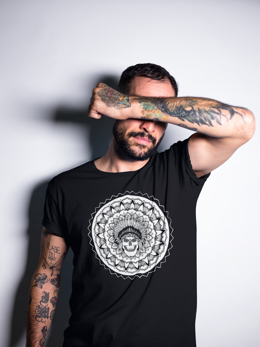 a tattooed man covering his face wearing a black chieftain mandala design t-shirt by mandalarian brand